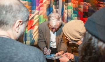 Award-winning director Costa-Gavras signs autographs for fans.
